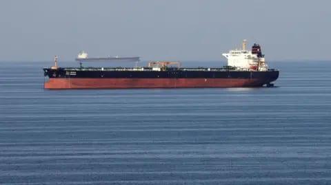 Iran says oil tanker caught fire near Hormuz after hitting mines | International